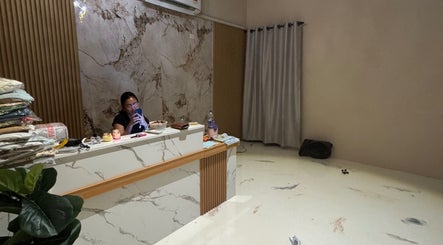Reception desk at Enchanté House of Beauty, Petaling Jaya, Selangor, MY with elegant marble decor.