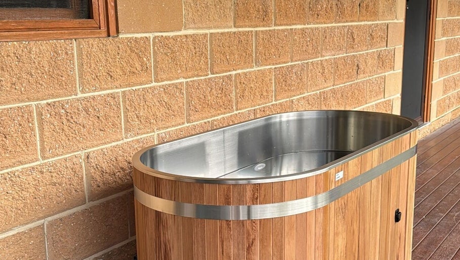 Luxurious wooden tub at Coachedbykarina, Catherine Field, New South Wales, AU offering a serene retreat.