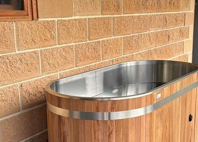 Luxurious wooden tub at Coachedbykarina, Catherine Field, New South Wales, AU offering a serene retreat.