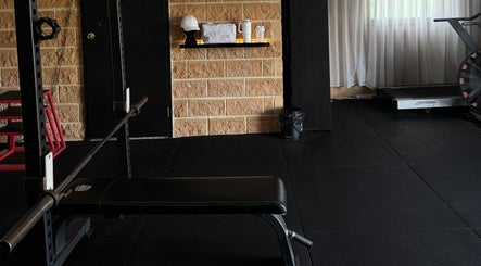 Modern fitness area at Coachedbykarina, Catherine Field, New South Wales, AU with bench press and treadmill.