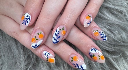 Artistic nail design at Leah nail studio, Kirkland, Washington, US, featuring orange fruit motifs.