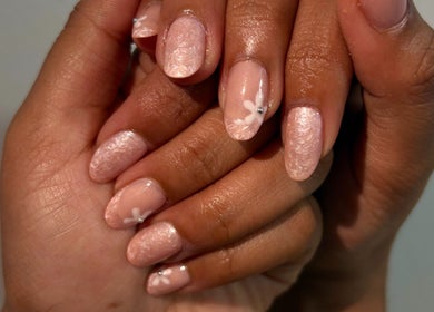 Close-up of elegant floral nail art at NailsbyHashy, Malé City, Kaafu Atoll, MV. Soft pink shimmer with white flowers.