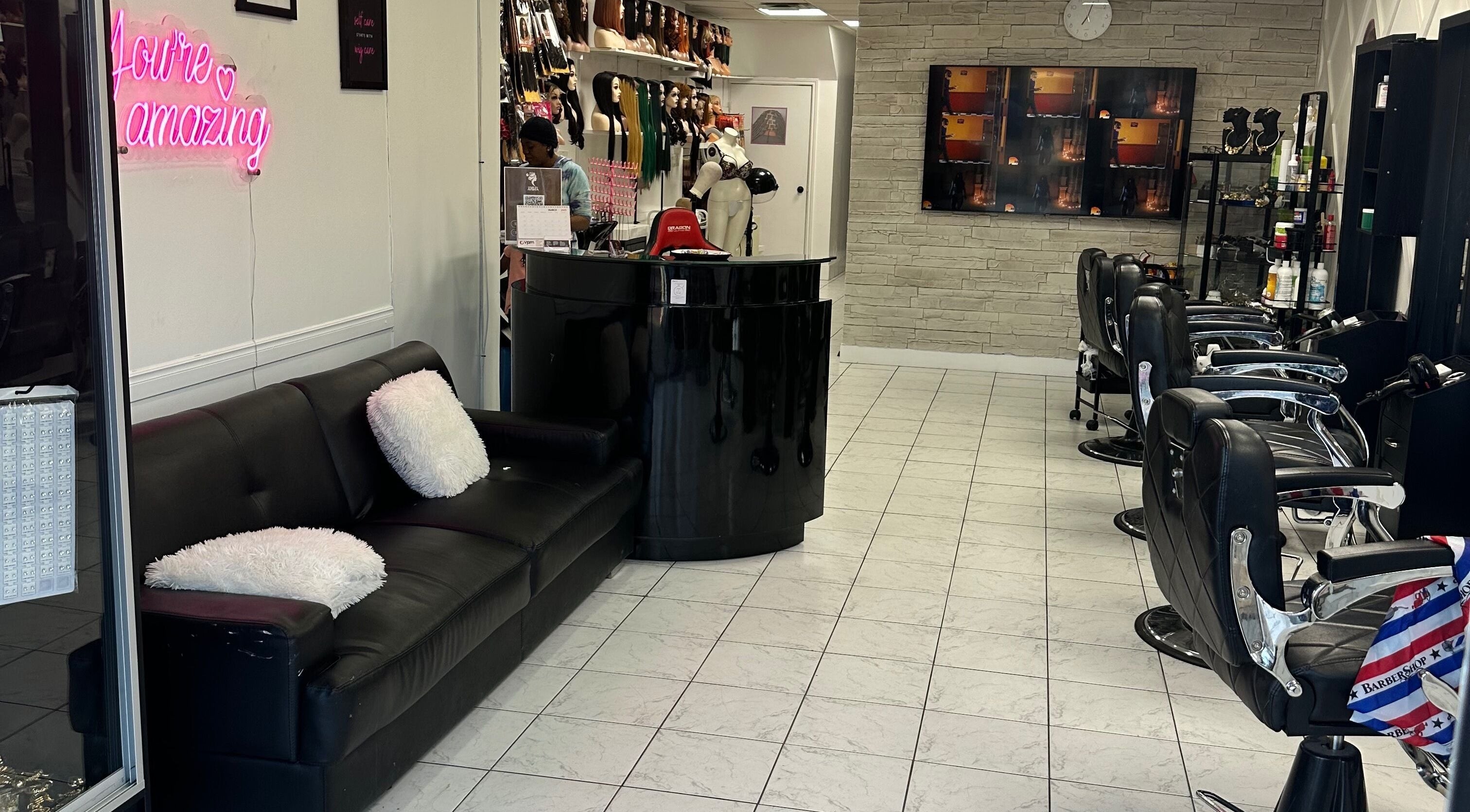 Aisha Hair Empire Inc., Toronto salon with sleek chairs, stylish decor, and inviting lounge area.