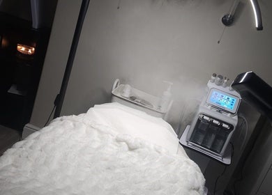 Luxurious treatment room at Enhanced by Hannah, Workington, England, GB. Features cozy bed and advanced skincare machine.