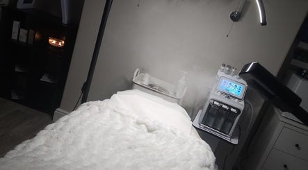 Luxurious treatment room at Enhanced by Hannah, Workington, England, GB. Features cozy bed and advanced skincare machine.
