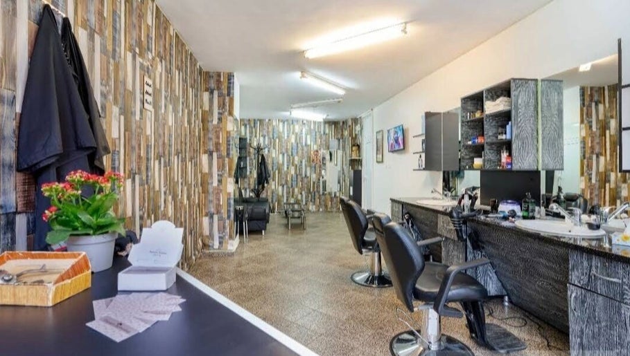 Chic interior of Elegance Barbershop in Plovdiv, Plovdiv, BG with stylish chairs and decor.
