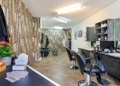 Chic interior of Elegance Barbershop in Plovdiv, Plovdiv, BG with stylish chairs and decor.