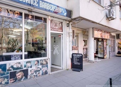 Exterior of Elegance Barbershop in Plovdiv, Plovdiv, BG showcasing trendy hairstyles on display.