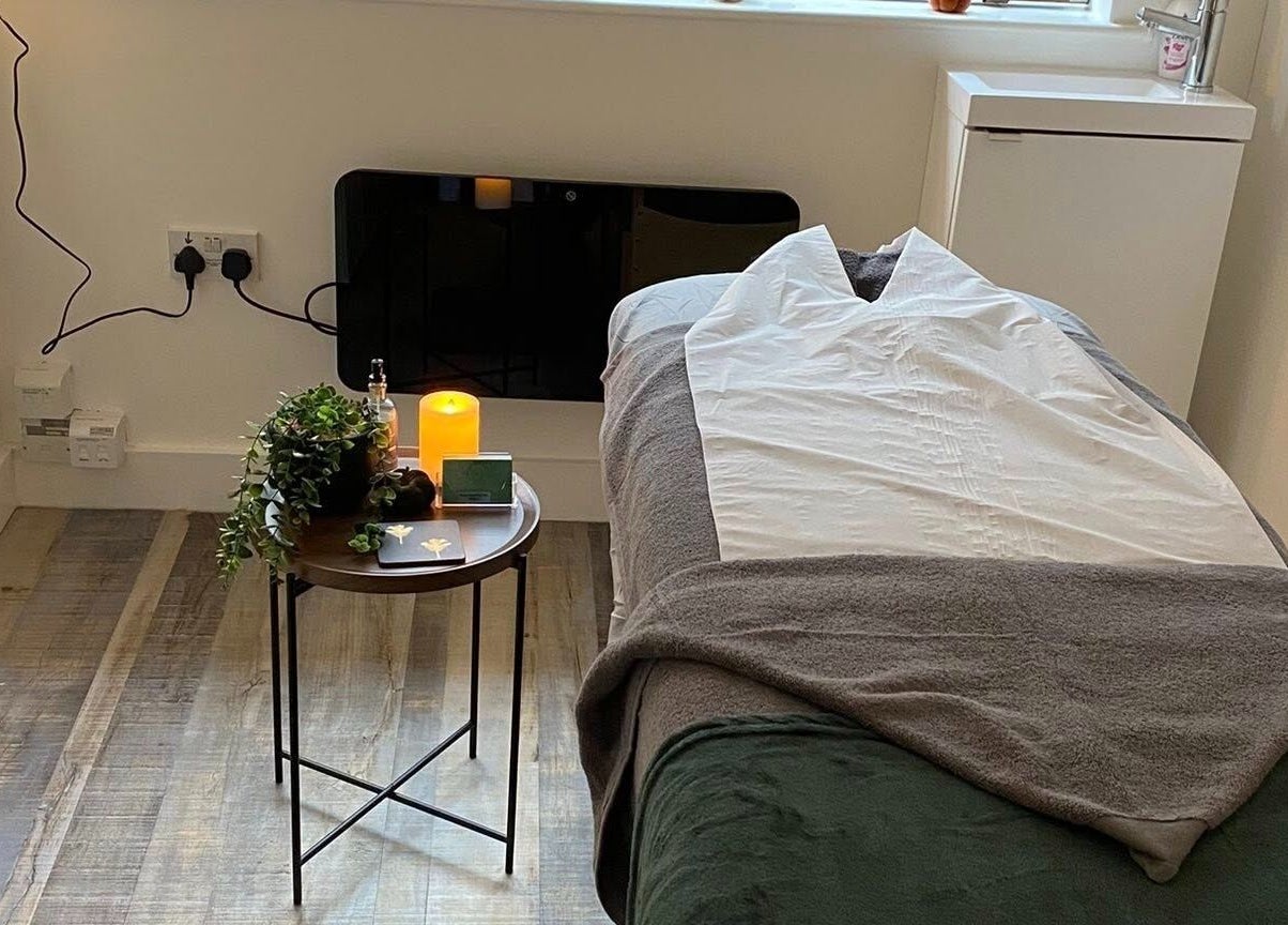Cozy massage room at Pure Serenity By Hope in Norwich, England, GB with candlelit ambiance.
