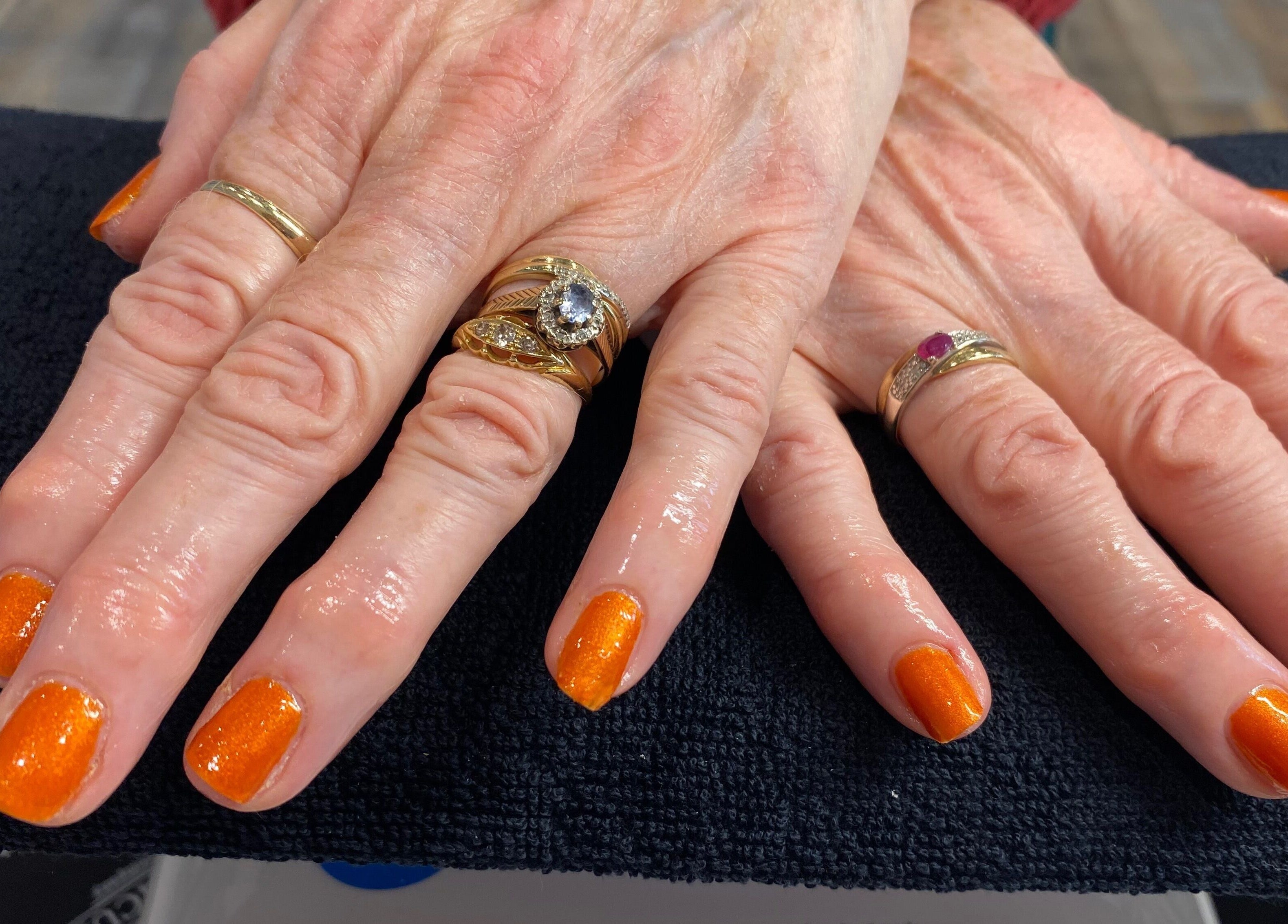 Vibrant orange manicured nails at Pure Serenity By Hope, Norwich, England, GB.