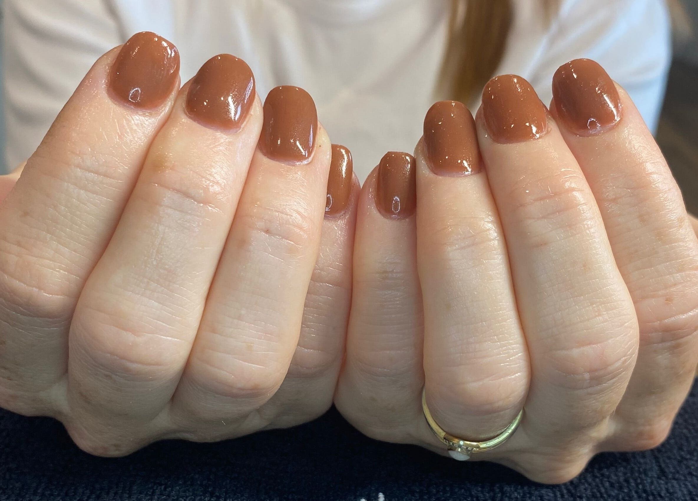Brown polished nails at Pure Serenity By Hope, Norwich, England, GB displaying natural elegance.