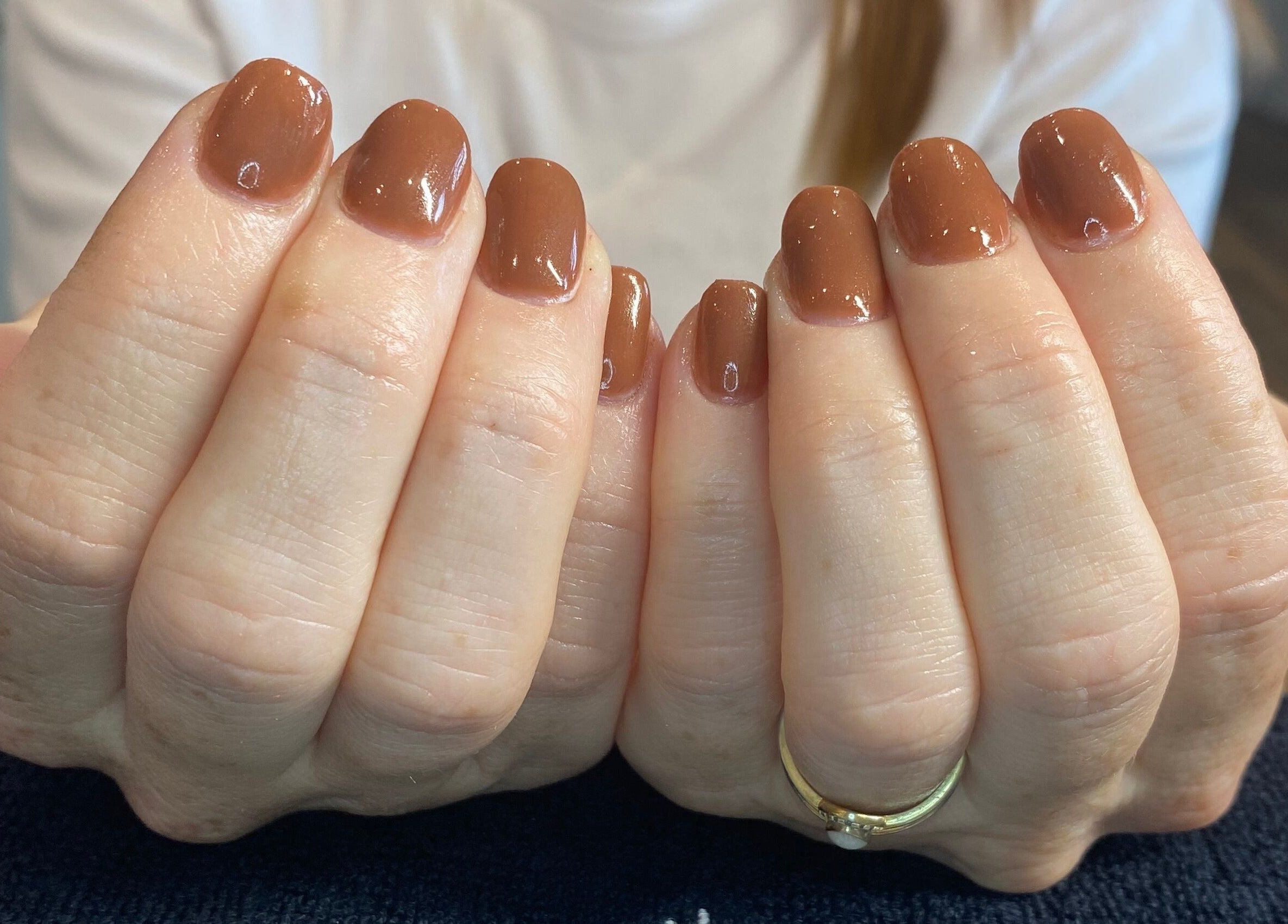 Brown polished nails at Pure Serenity By Hope, Norwich, England, GB displaying natural elegance.