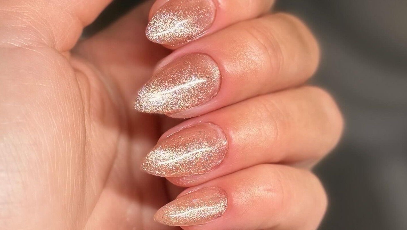 Sparkling nude manicure at Addy Artisan, Forres, Scotland, GB showcases elegance with glitter finish.
