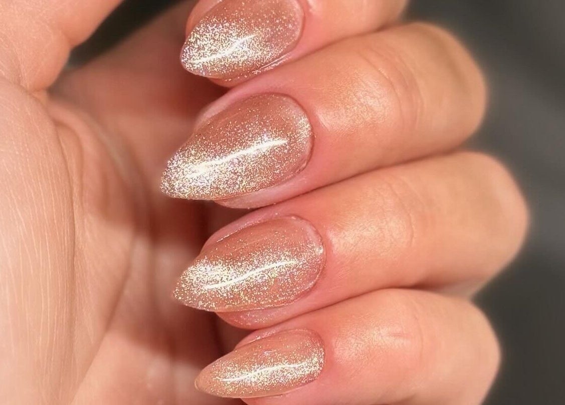 Sparkling nude manicure at Addy Artisan, Forres, Scotland, GB showcases elegance with glitter finish.