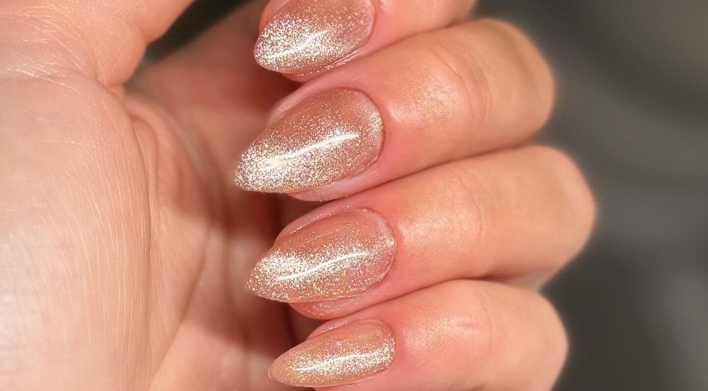 Sparkling nude manicure at Addy Artisan, Forres, Scotland, GB showcases elegance with glitter finish.