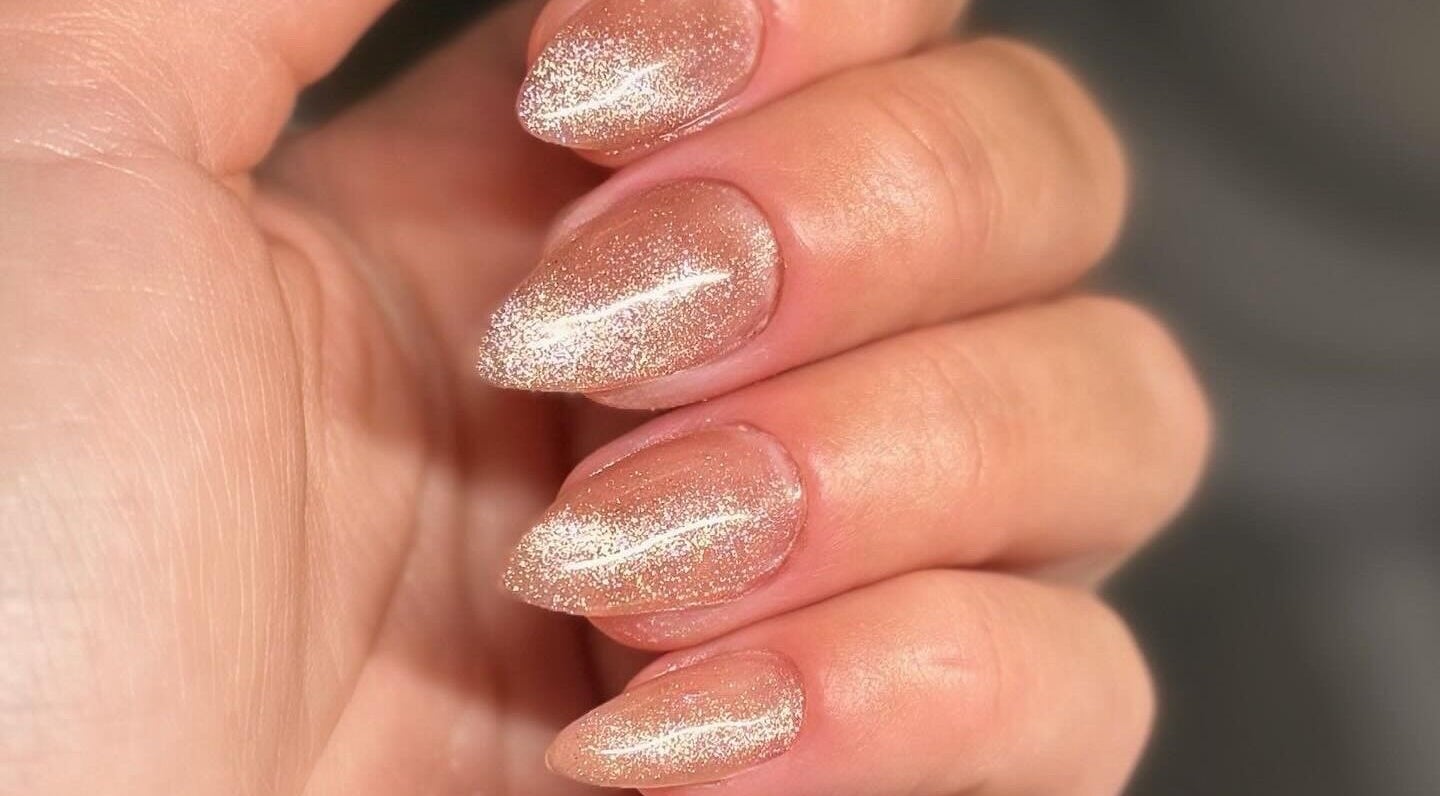 Sparkling nude manicure at Addy Artisan, Forres, Scotland, GB showcases elegance with glitter finish.