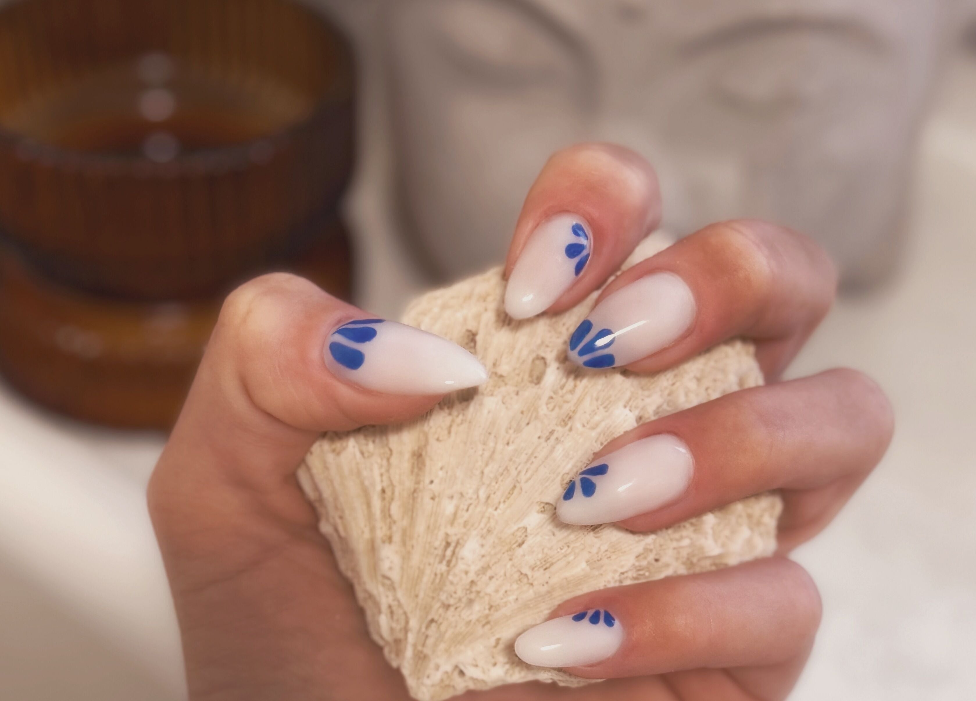 Chic blue nail art on manicured hand at Addy Artisan, Forres, Scotland, GB. Enhancing natural elegance.
