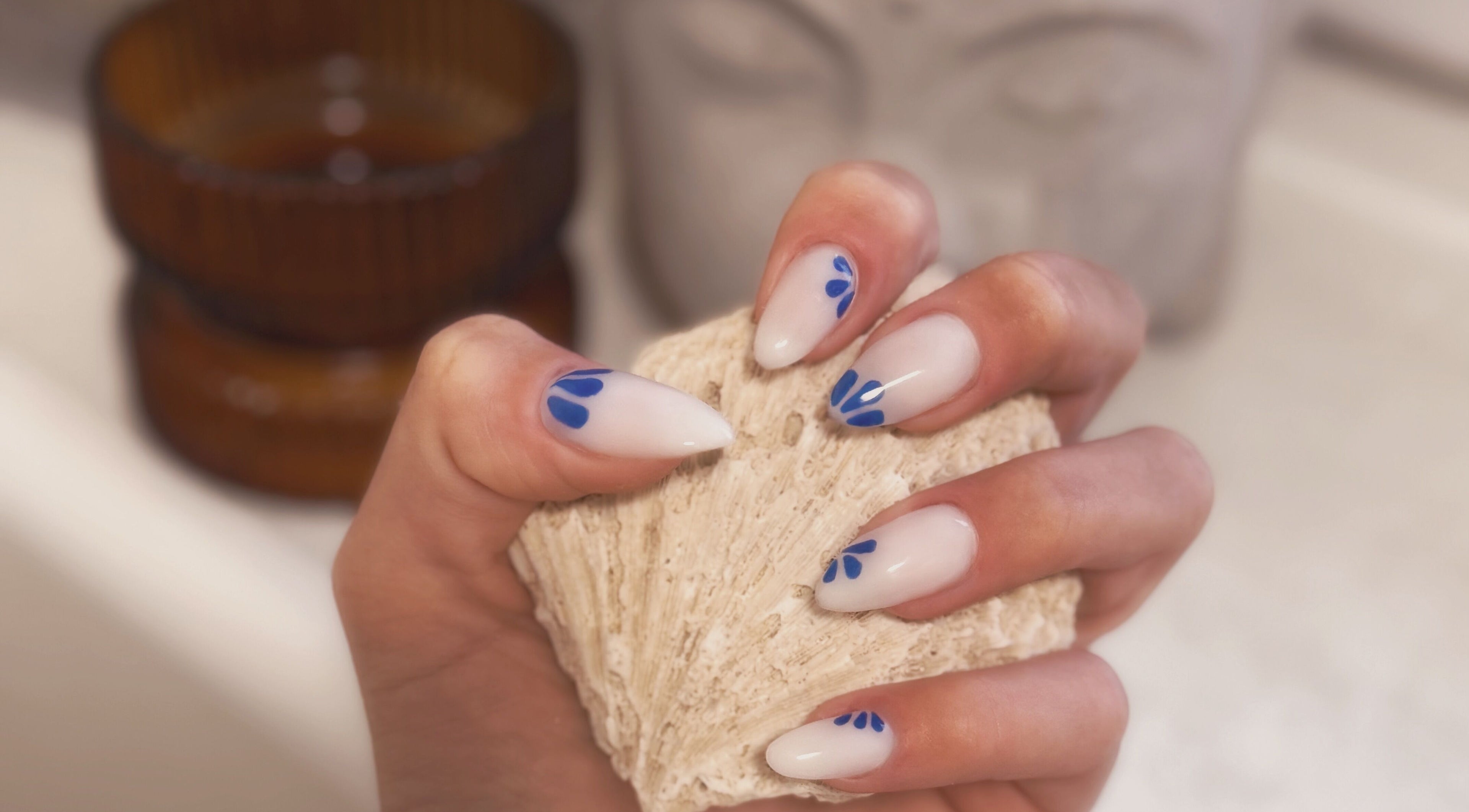 Chic blue nail art on manicured hand at Addy Artisan, Forres, Scotland, GB. Enhancing natural elegance.