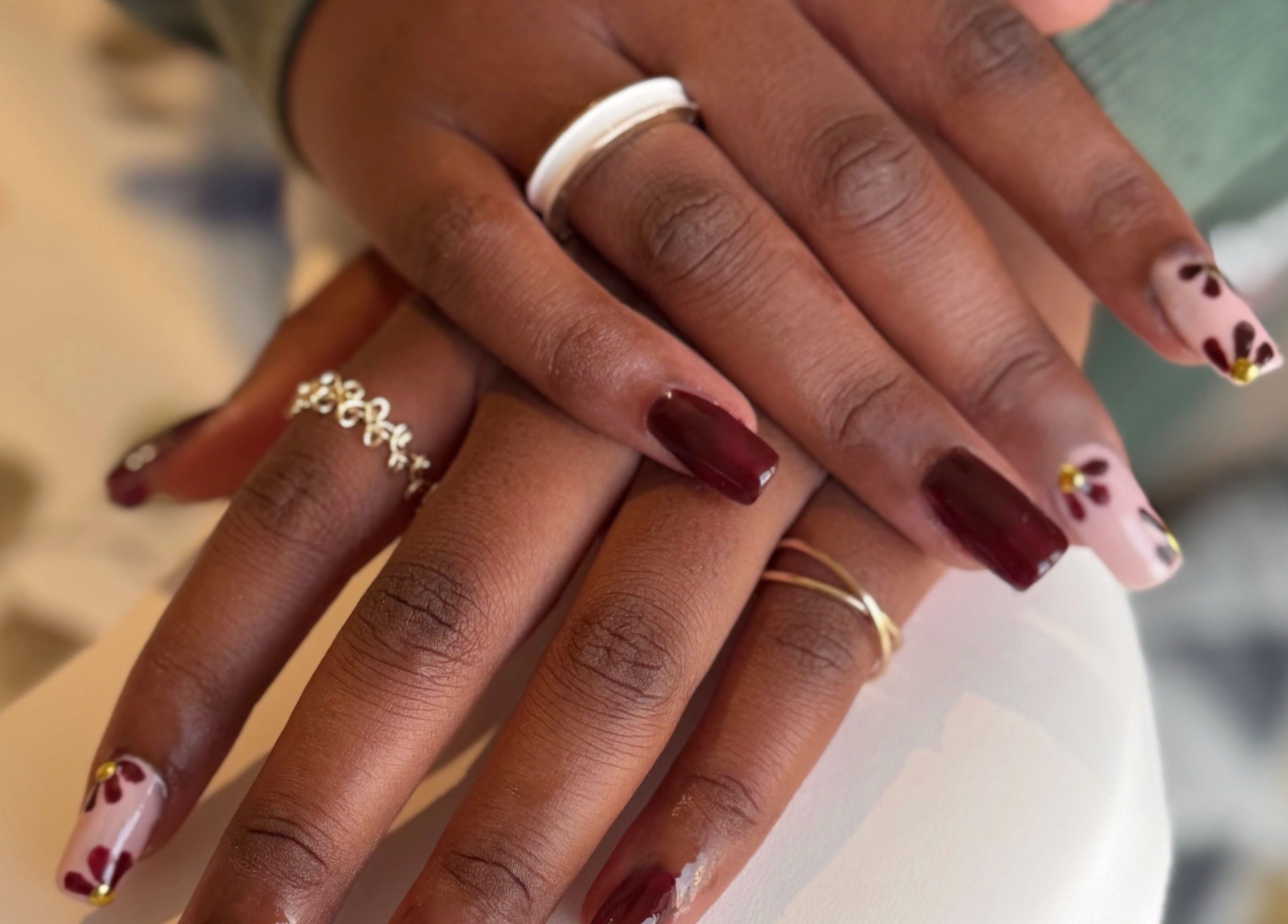 Beautiful nail art and rings at Addy Artisan, Forres, Scotland, GB, showcasing detailed floral designs.