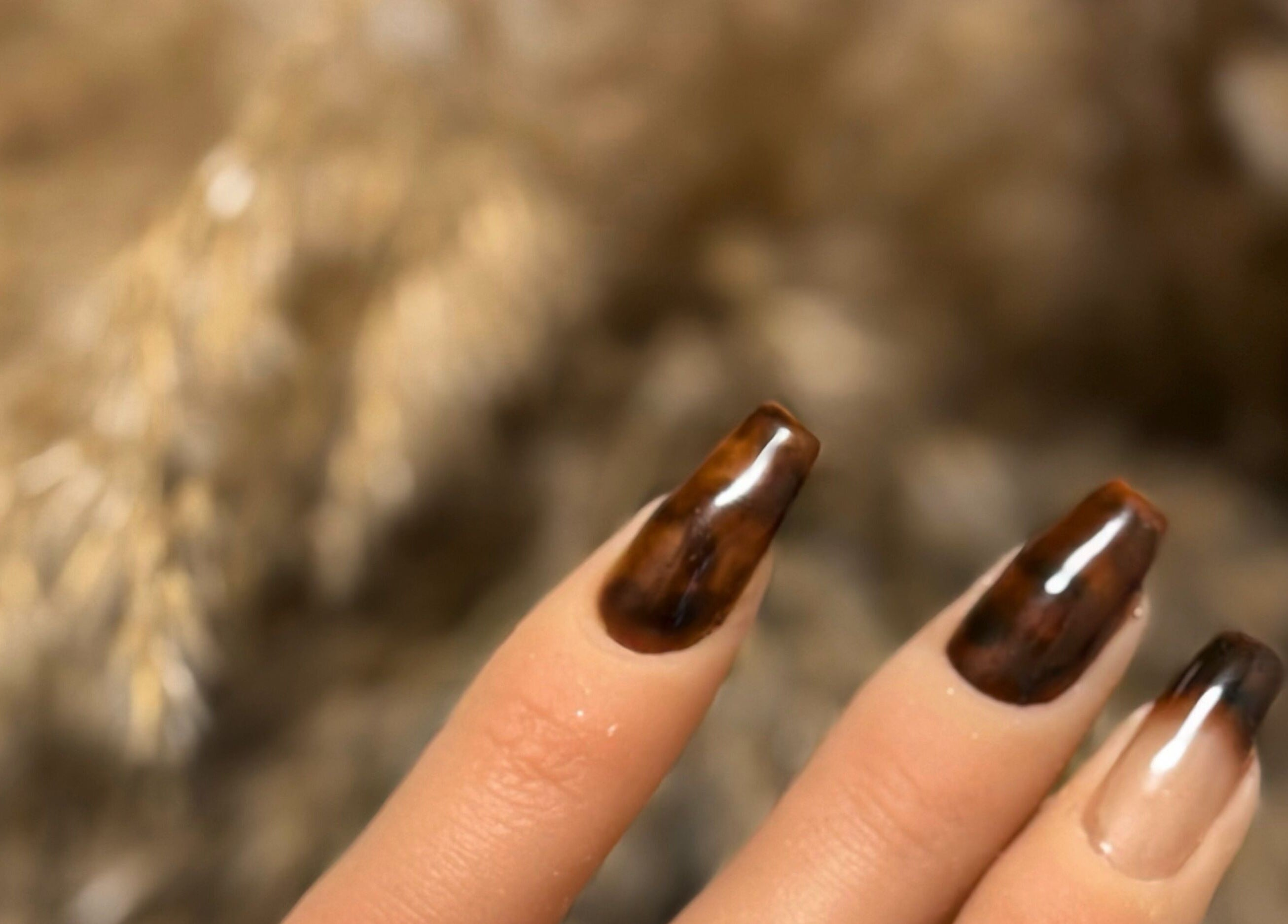 Close-up of elegant brown gradient nails at Addy Artisan, Forres, Scotland, GB.