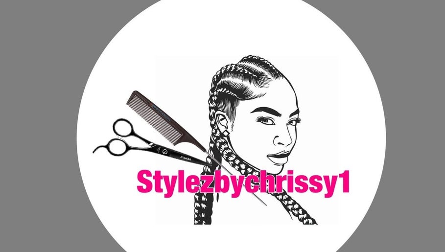 Logo of Stylezbychrissy with braids, scissors, and comb, Old Harbour, St. Catherine Parish, JM.