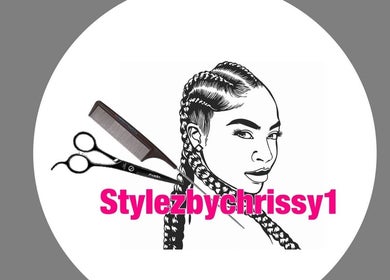 Logo of Stylezbychrissy with braids, scissors, and comb, Old Harbour, St. Catherine Parish, JM.