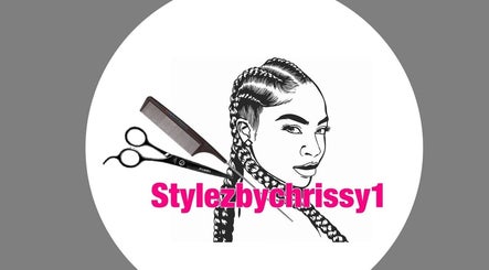 Logo of Stylezbychrissy with braids, scissors, and comb, Old Harbour, St. Catherine Parish, JM.