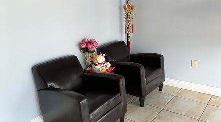 Cozy waiting area with leather chairs and decor at Lotus Spa Miami, Miami, Florida, US.