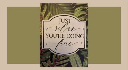 Inspirational sign at BAUS, Twin Falls, Idaho, US: 'Just relax, you're doing fine' with leafy background.