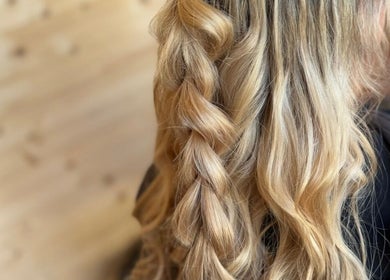 Elegant braided hairstyle at KB Hair, Winchester, England, GB showcasing smooth golden locks.