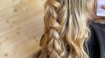 Elegant braided hairstyle at KB Hair, Winchester, England, GB showcasing smooth golden locks.