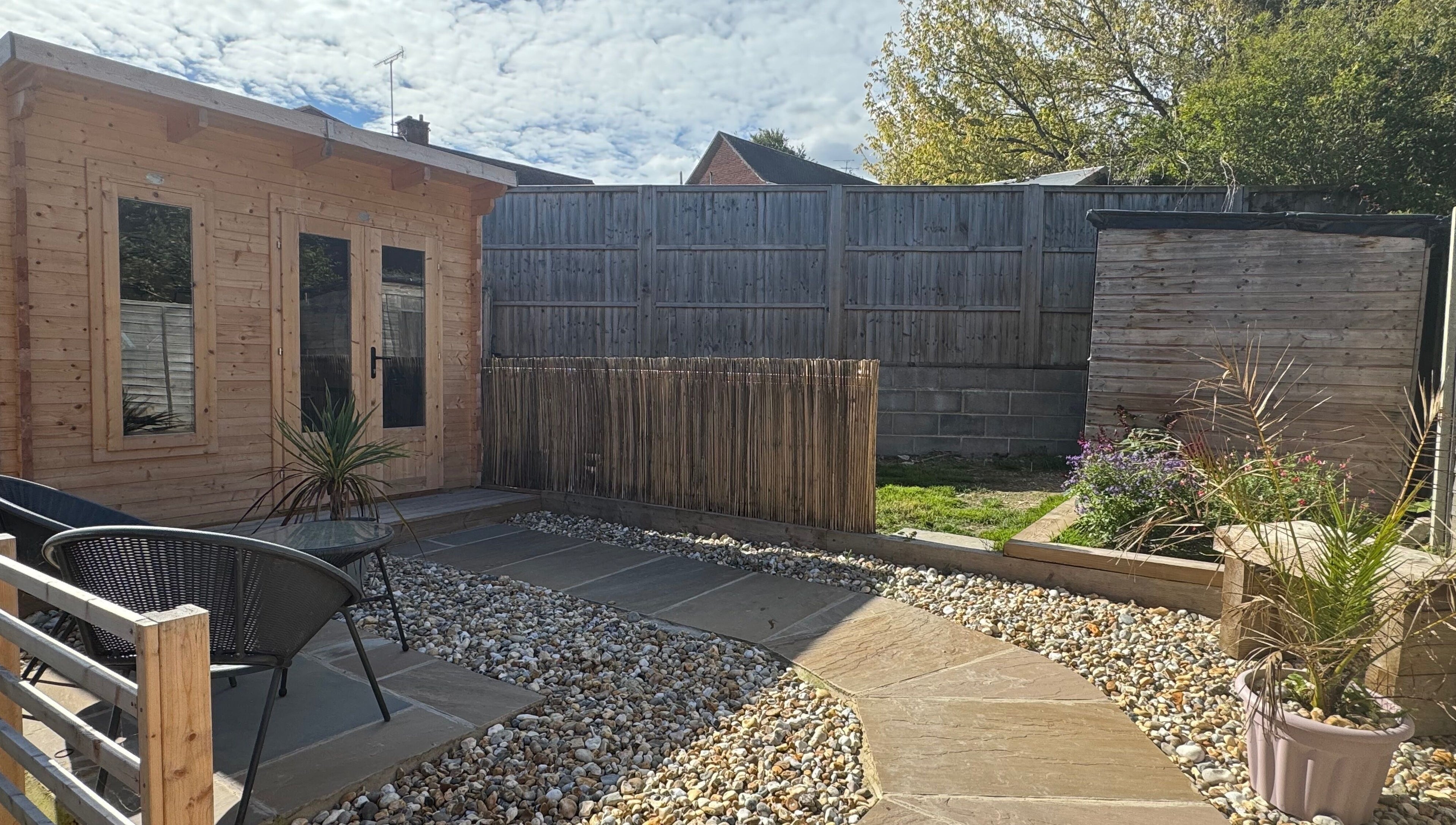 Relaxing garden area at KB Hair, featuring seating and greenery in Winchester, England, GB.