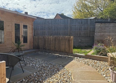 Relaxing garden area at KB Hair, featuring seating and greenery in Winchester, England, GB.
