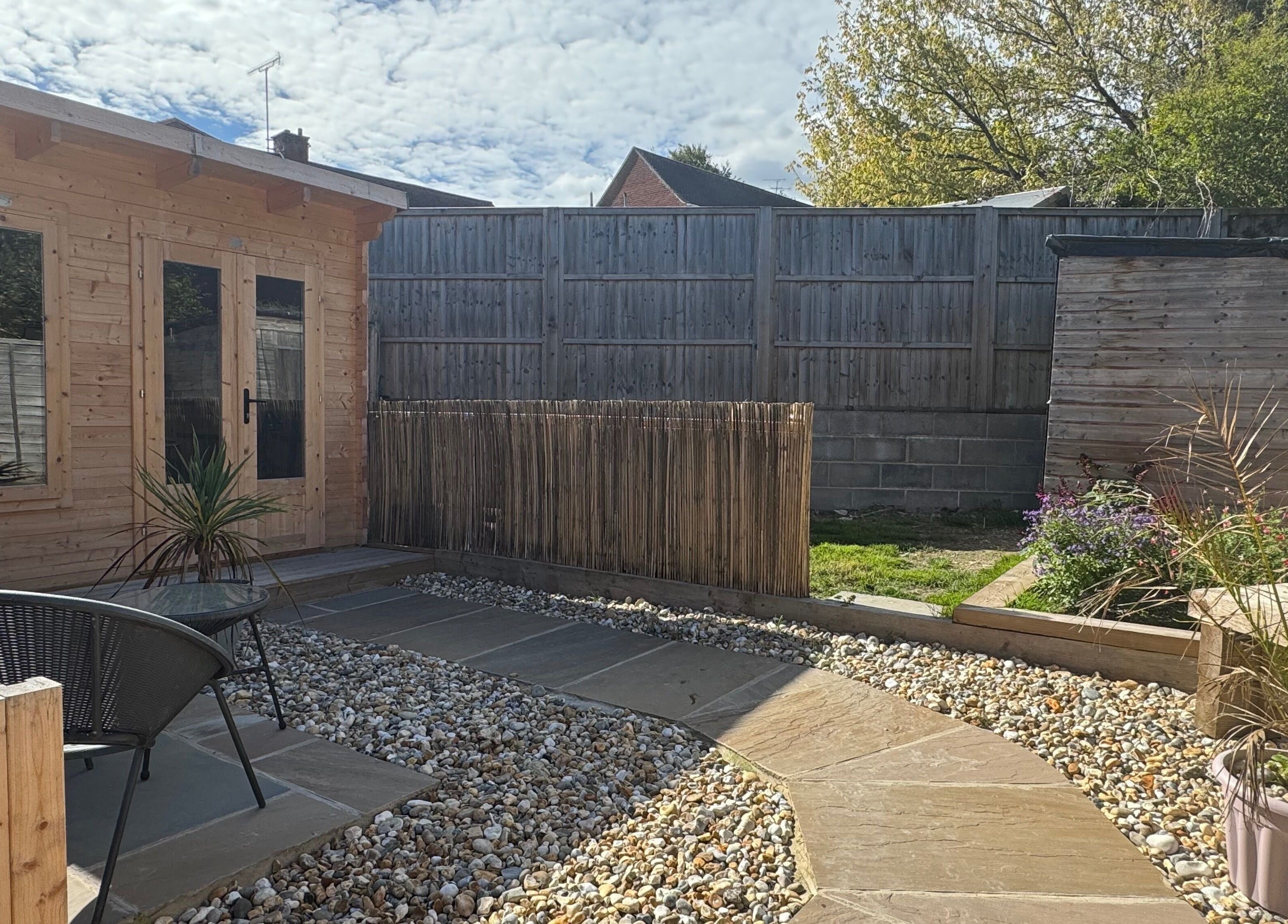 Relaxing garden area at KB Hair, featuring seating and greenery in Winchester, England, GB.