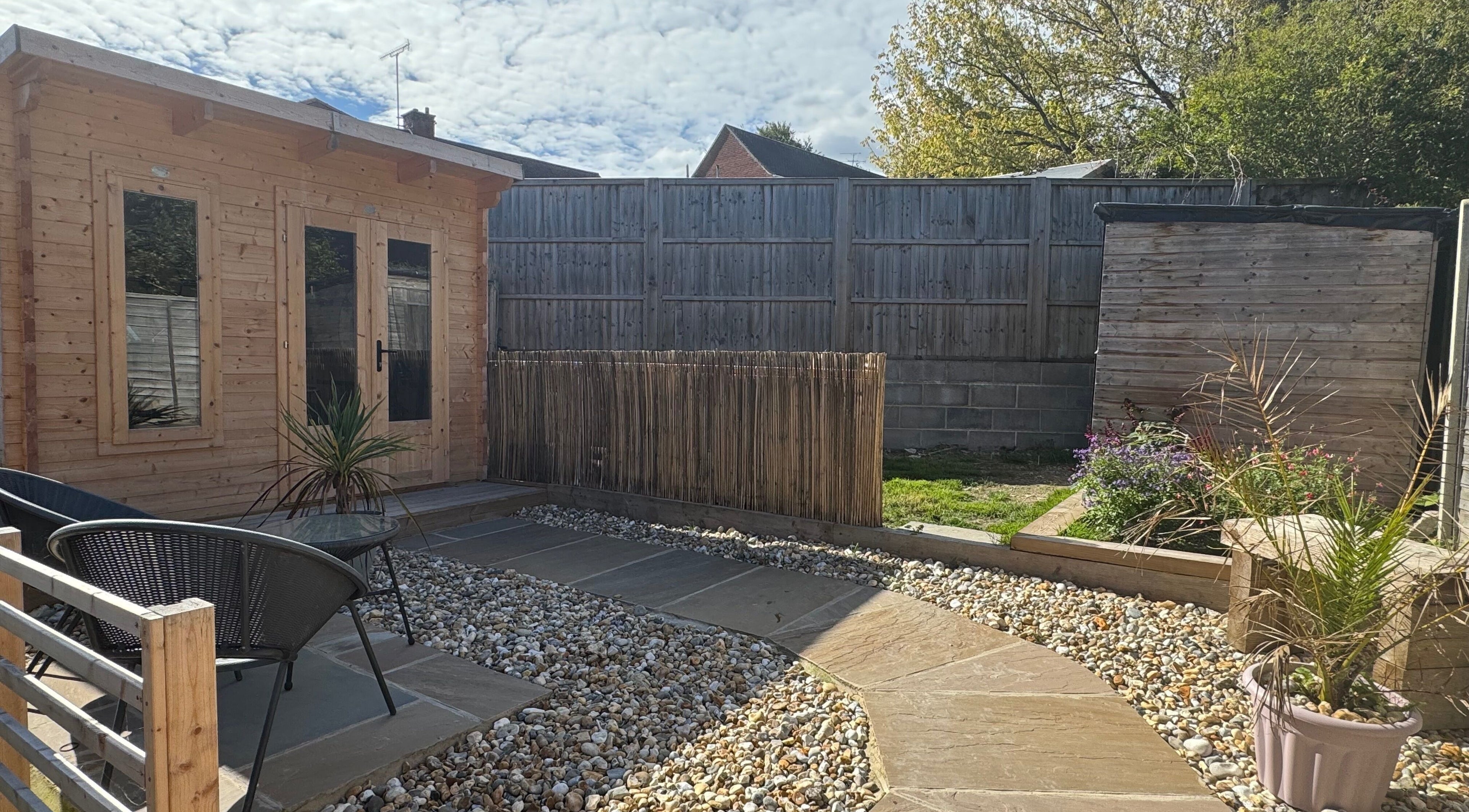 Relaxing garden area at KB Hair, featuring seating and greenery in Winchester, England, GB.