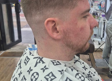Man with new haircut at Daniel Somers, Glasgow, Scotland, GB, highlighting modern grooming.