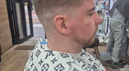 Man with new haircut at Daniel Somers, Glasgow, Scotland, GB, highlighting modern grooming.