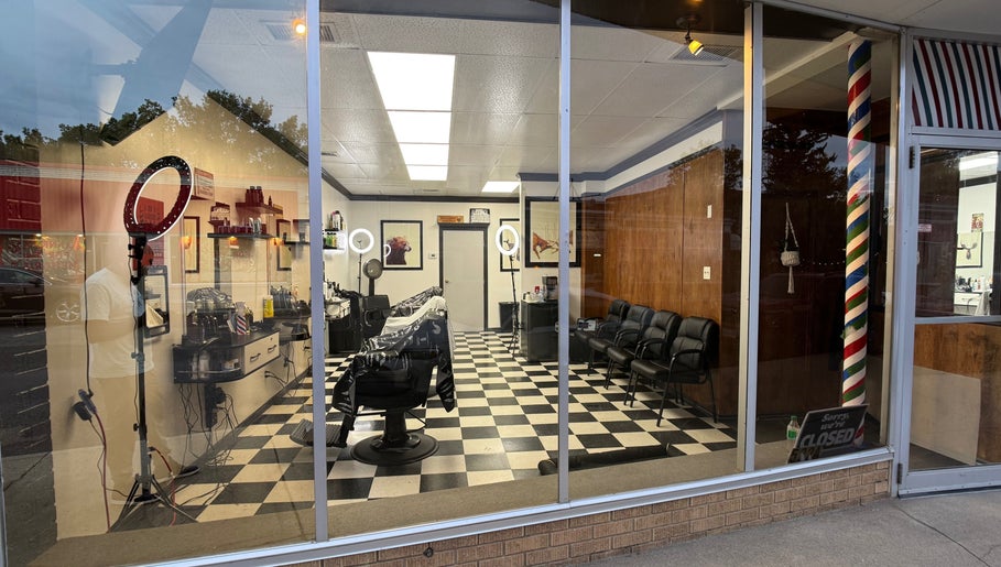 Interior of Good Fellas Barbershop in Medicine Hat, Alberta, CA, showcasing classic barber chairs and checkered flooring.