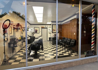 Interior of Good Fellas Barbershop in Medicine Hat, Alberta, CA, showcasing classic barber chairs and checkered flooring.