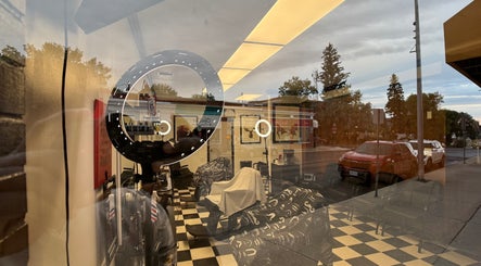 Interior view of Good Fellas Barbershop through window reflection in Medicine Hat, Alberta, CA.