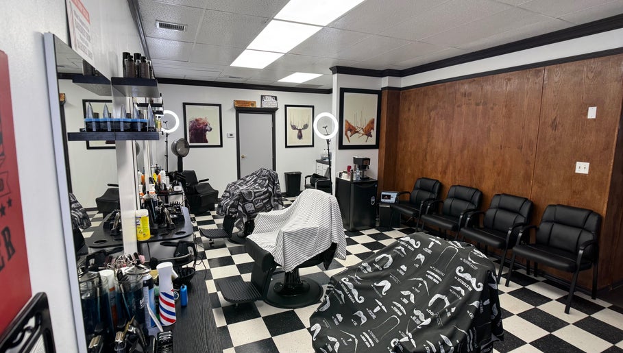 Interior of Kwes Kuts DBA Good Fellas Barbershop, Medicine Hat, Alberta, CA, featuring stylish chairs and decor.
