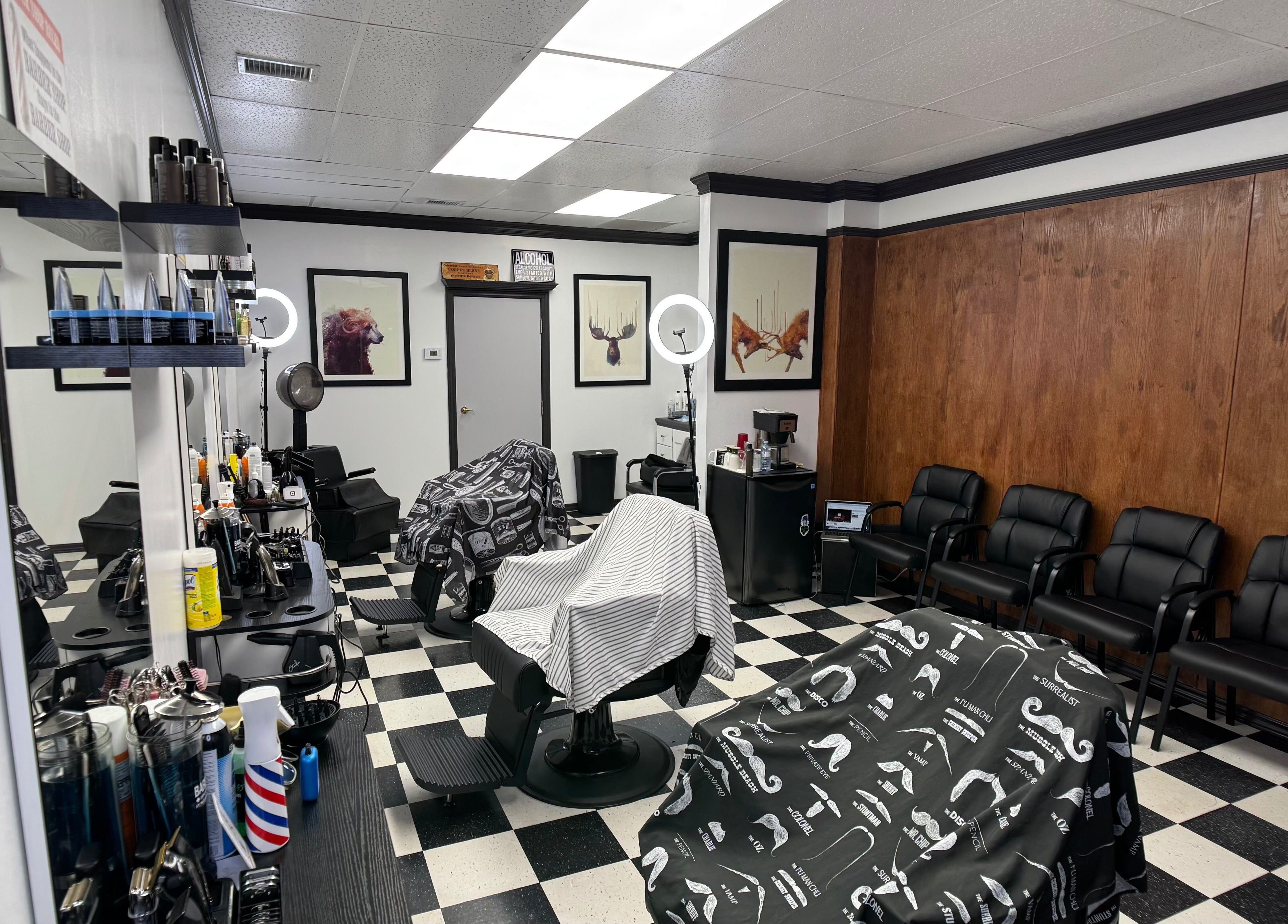 Interior of Kwes Kuts DBA Good Fellas Barbershop, Medicine Hat, Alberta, CA, featuring stylish chairs and decor.