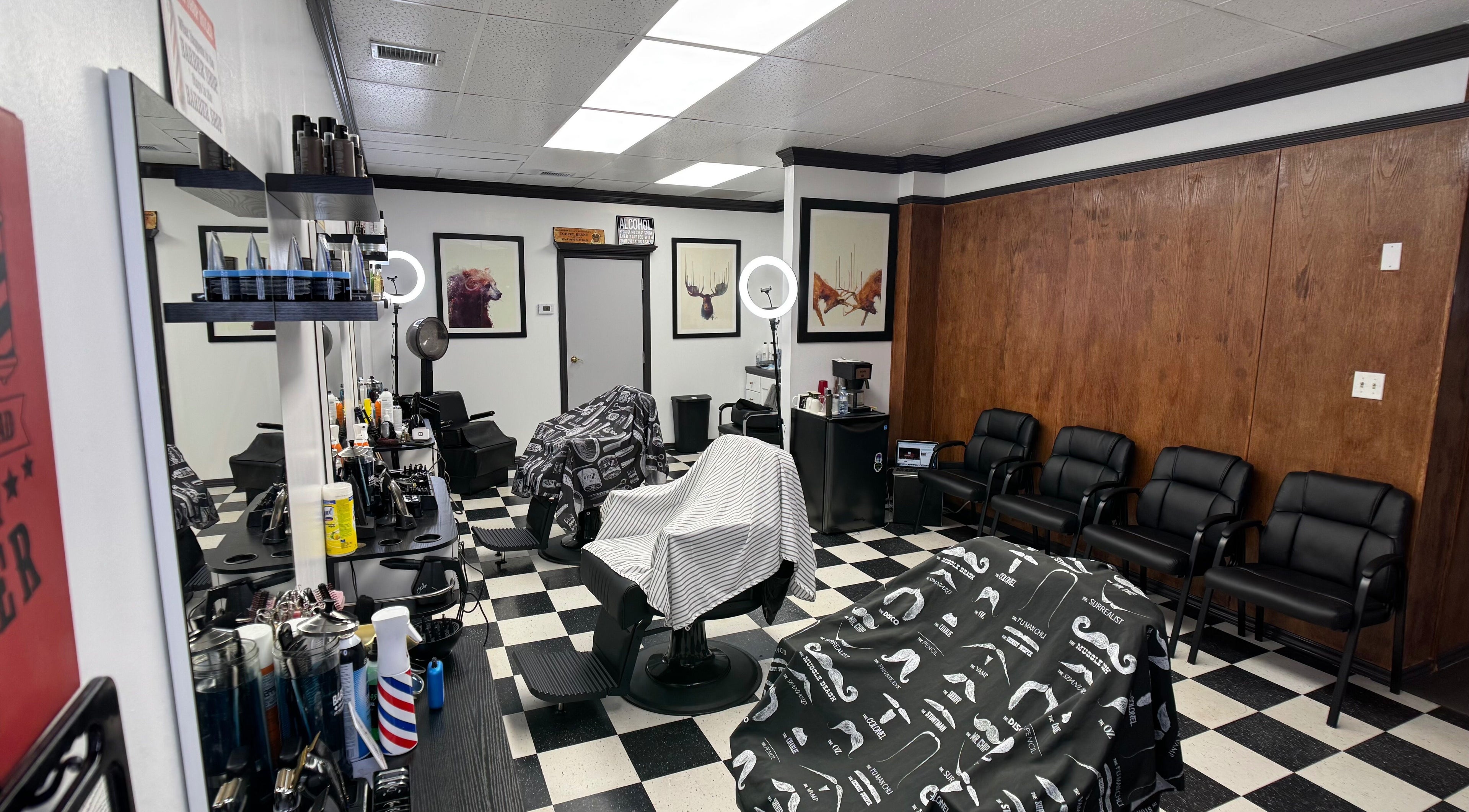 Interior of Kwes Kuts DBA Good Fellas Barbershop, Medicine Hat, Alberta, CA, featuring stylish chairs and decor.