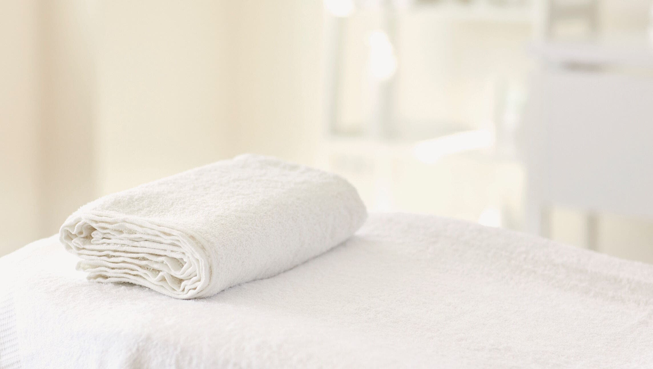 Soft white towel folded neatly at Hourglass BodyWorks, Slidell, Louisiana, US. Perfect for relaxation sessions.