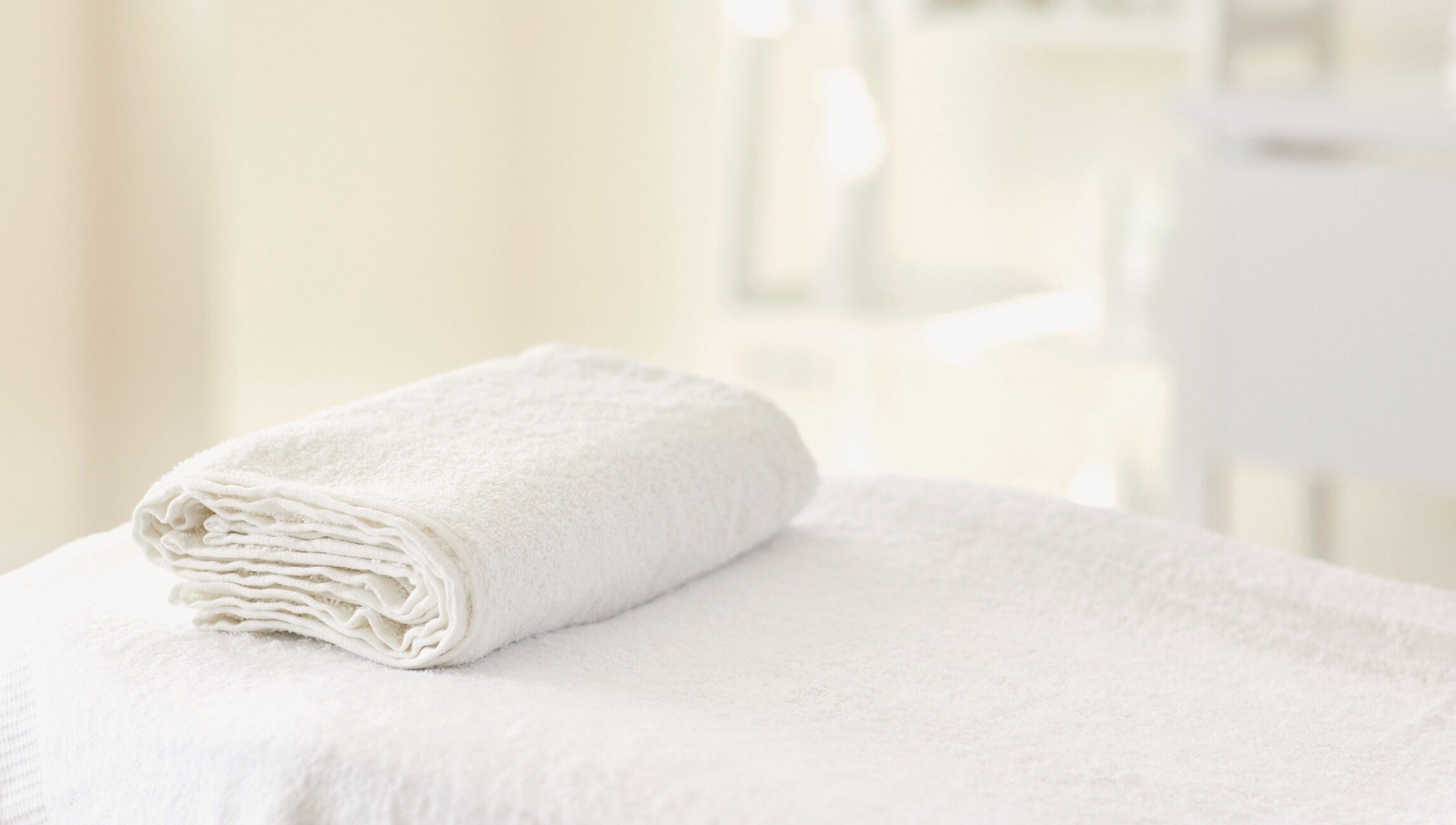 Soft white towel folded neatly at Hourglass BodyWorks, Slidell, Louisiana, US. Perfect for relaxation sessions.