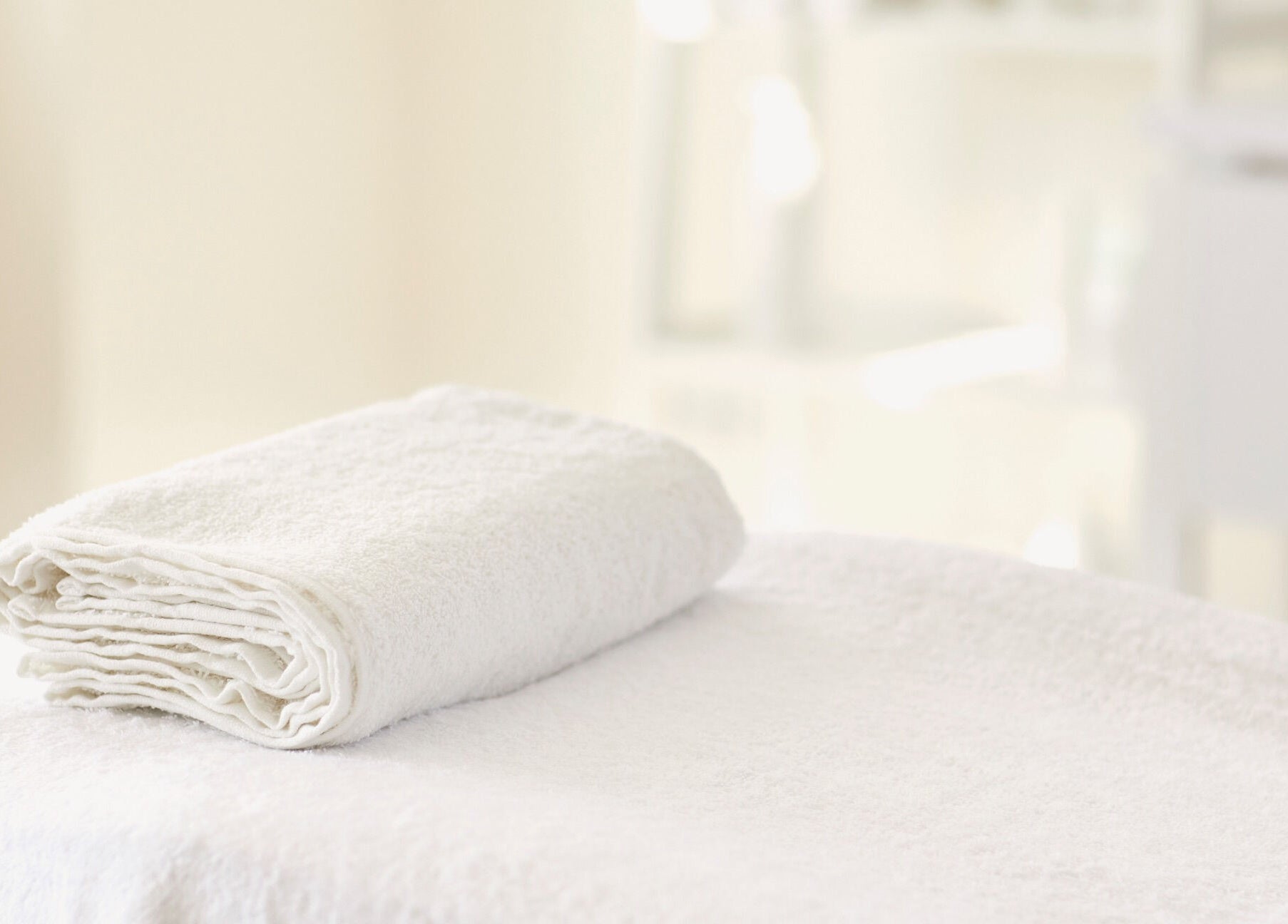 Soft white towel folded neatly at Hourglass BodyWorks, Slidell, Louisiana, US. Perfect for relaxation sessions.