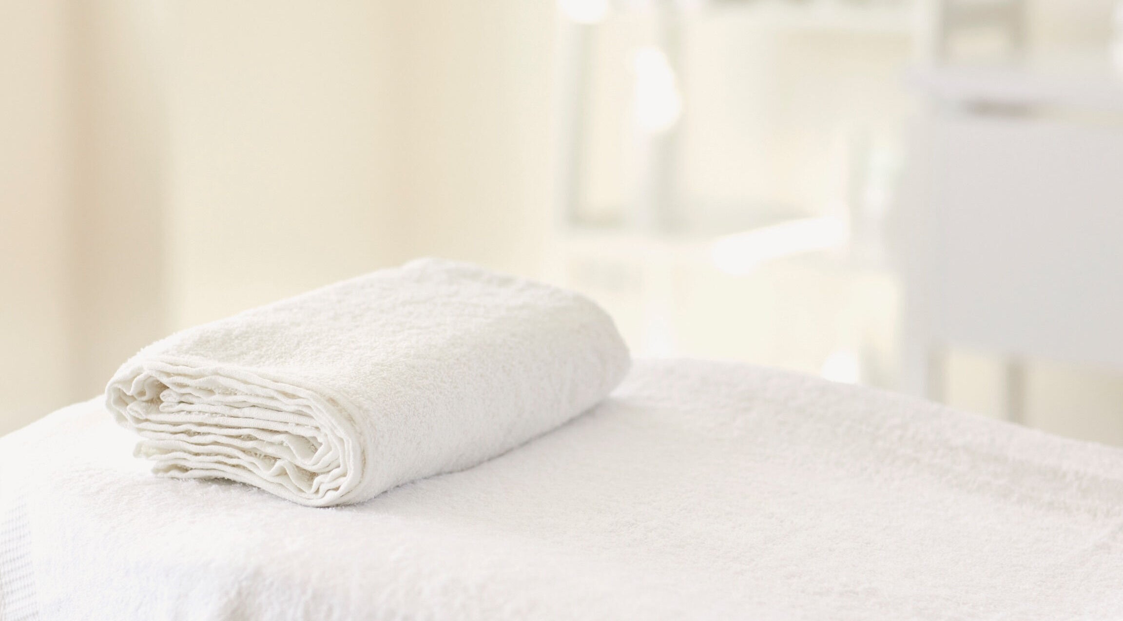 Soft white towel folded neatly at Hourglass BodyWorks, Slidell, Louisiana, US. Perfect for relaxation sessions.
