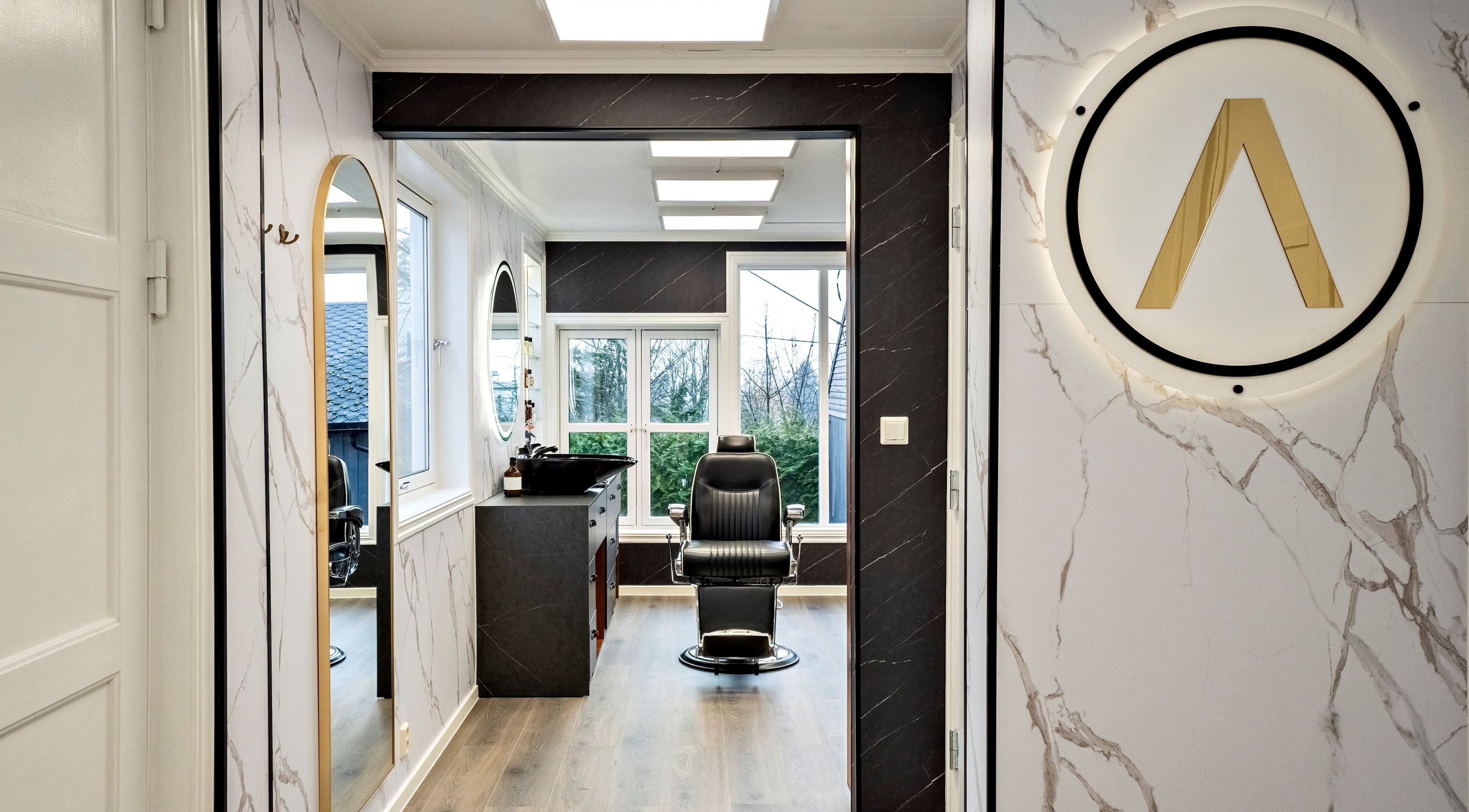 Romslig frisørsalong hos Alpha Grooming, Oslo, Oslo, NO, med moderne interiør og luksuriøs stol.