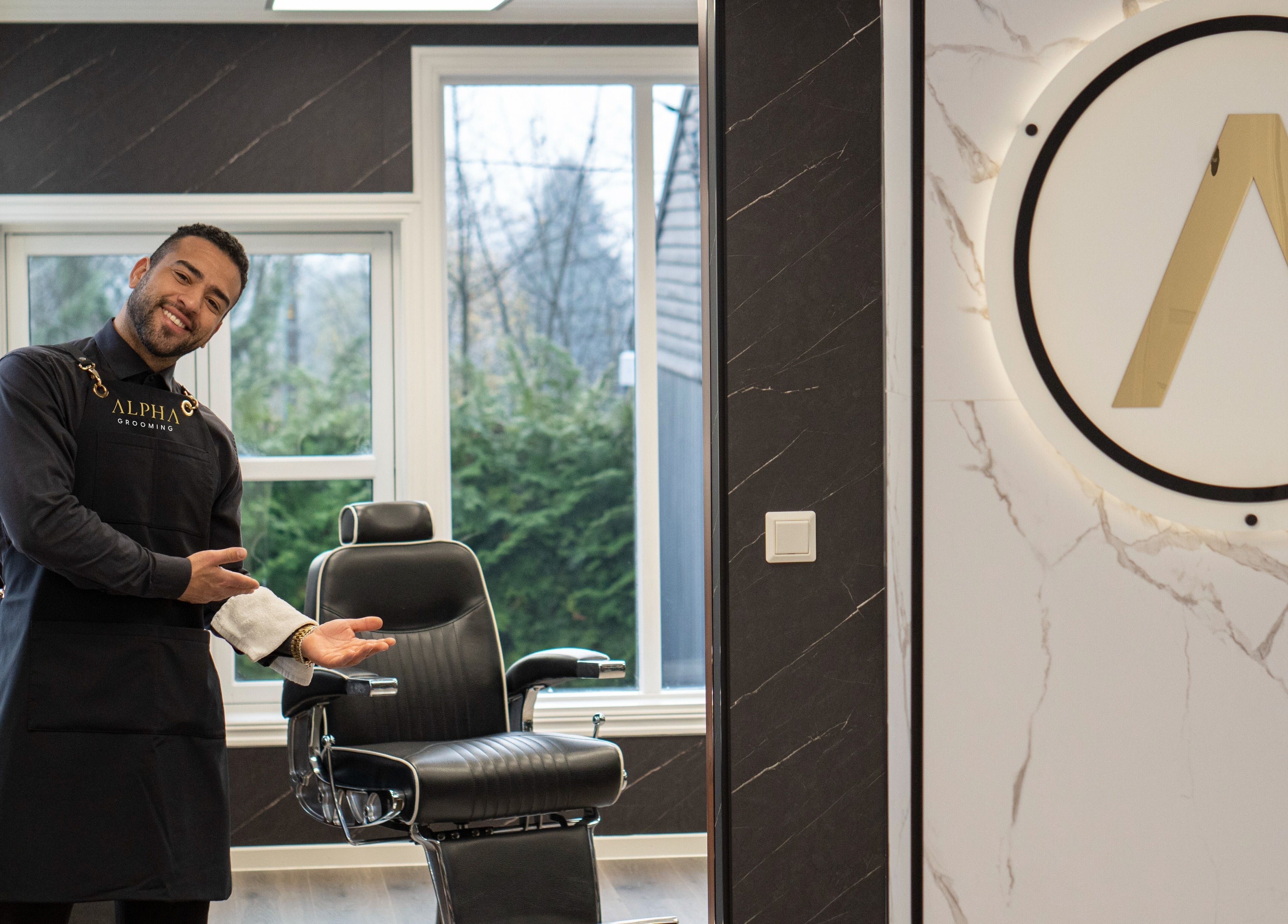 Profesjonell barberer ønsker velkommen i Alpha Grooming, Oslo, Oslo, NO, med elegant stol og moderne design.