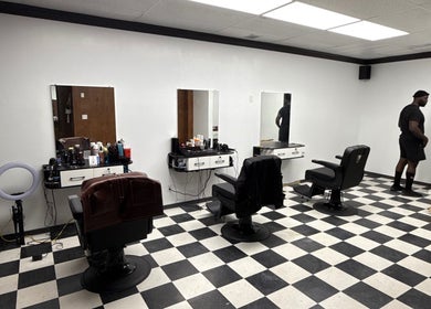 Chic interior of Carlos the Barber in Medicine Hat, Alberta, CA with modern barber chairs and equipment.